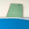 Blue shape with green thing on top 